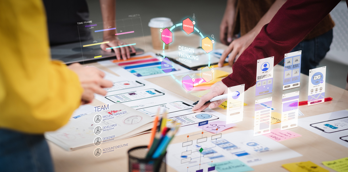 Close up ux developer and ui designer use augmented reality brainstorming about mobile app interface wireframe design on desk at modern office. Creative digital development agency